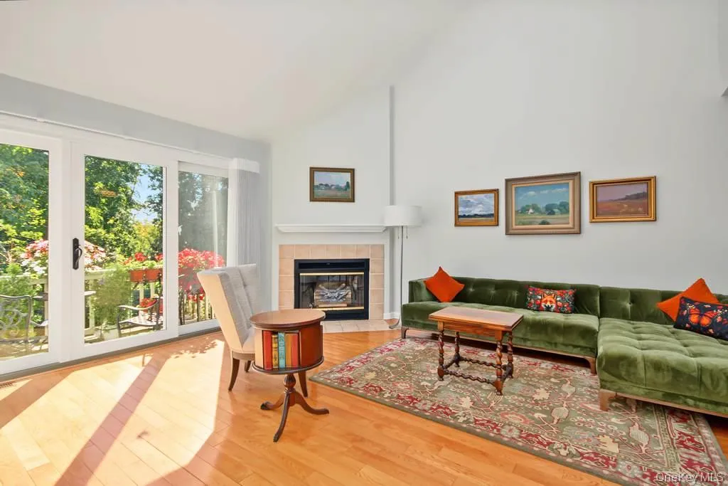 Living room has a fireplace with mantle and SGD to Deck Living room has a fireplace with mantle and SGD to Deck