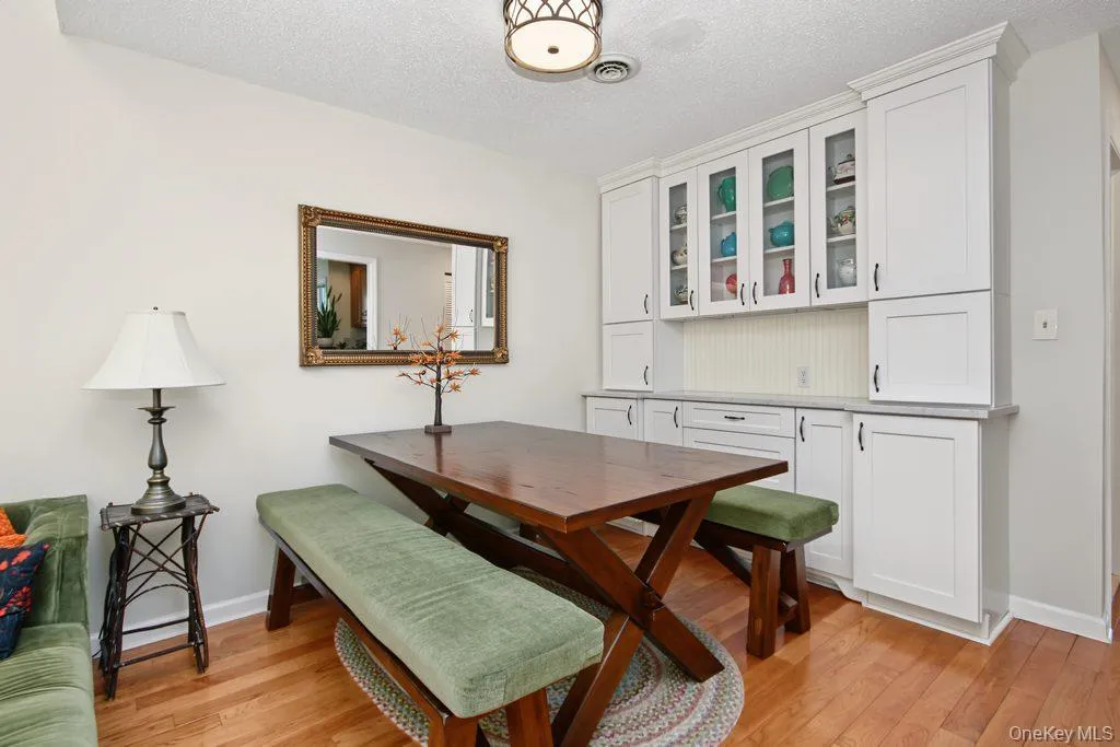 Dining room has hardwood floors and built in wall unit with marble top Dining room has hardwood floors and built in wall unit with marble top