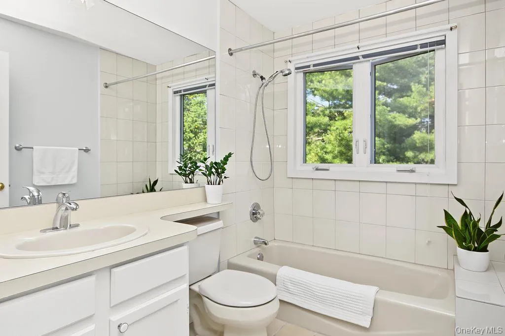 Bathroom has sink with vanity and bathtub with shower combo Bathroom has sink with vanity and bathtub with shower combo