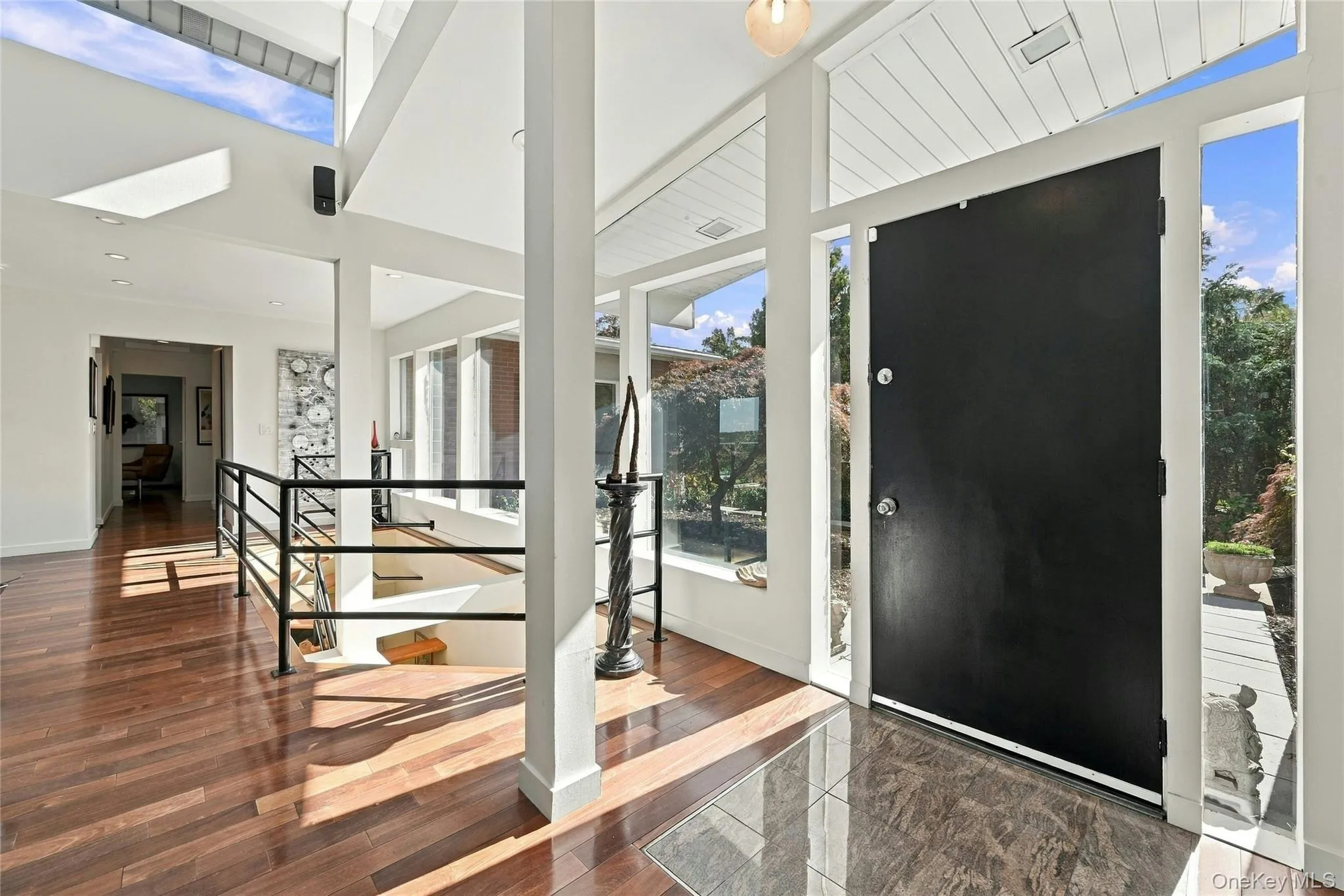 Entryway featuring Hardwood flooring, high ceilings, recessed lighting, and expansive floor-to-ceiling windows Entryway featuring Hardwood flooring, high ceilings, recessed lighting, and expansive floor-to-ceiling windows