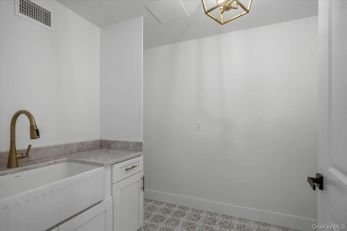 Laundry room with farm sink, cabinets and hook up for washer and dryer Laundry room with farm sink, cabinets and hook up for washer and dryer
