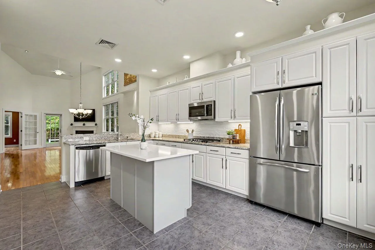 Large eat in kitchen with center island, stainless steel appliances and under cabinet lighting. Large eat in kitchen with center island, stainless steel appliances and under cabinet lighting.