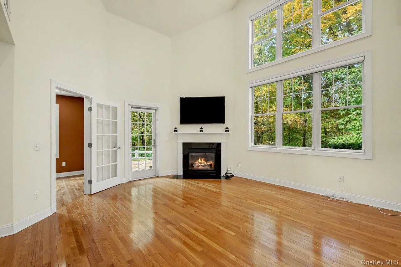 Bright and sunfilled living room featuring double windows with custom automatic window treatments. Bright and sunfilled living room featuring double windows with custom automatic window treatments.