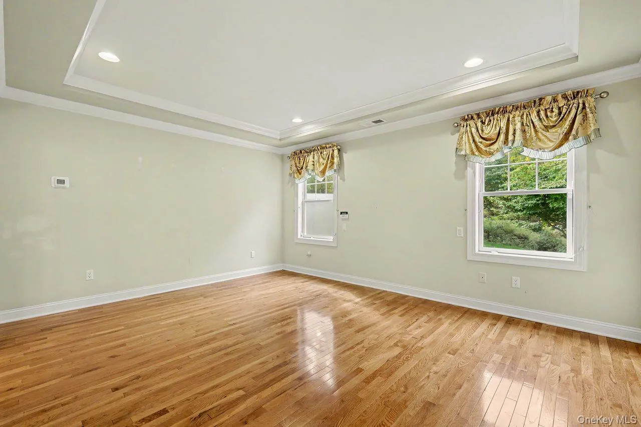 Primary bedroom with tray ceiling and hi-hats. Primary bedroom with tray ceiling and hi-hats.