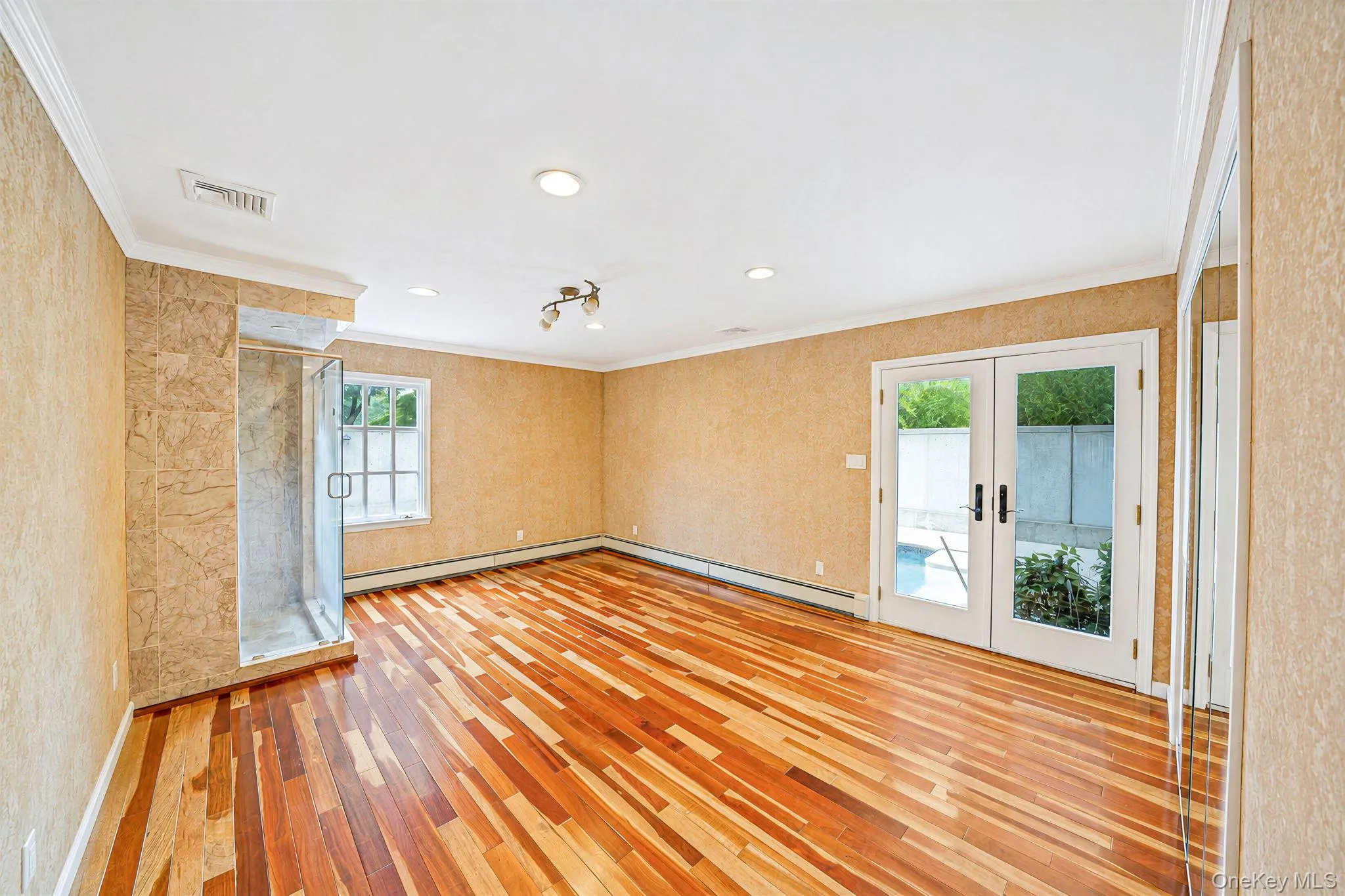 Primary BR -with private shower, access to backyard and pool, wood floor Primary BR -with private shower, access to backyard and pool, wood floor