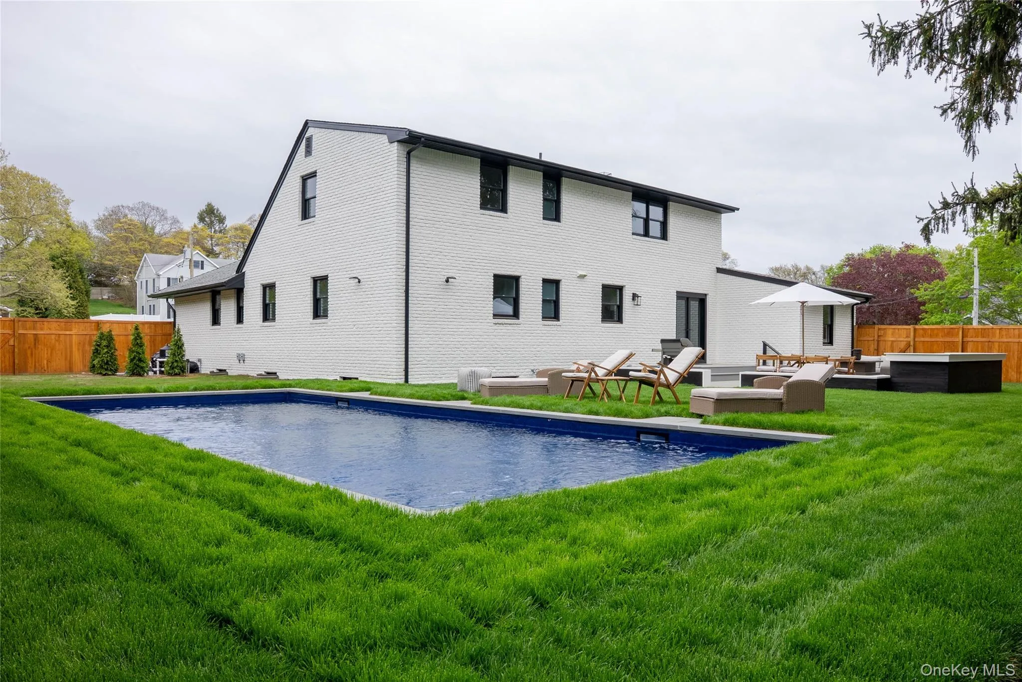 Rear view of property featuring a patio area and an outdoor living space Rear view of property featuring a patio area and an outdoor living space