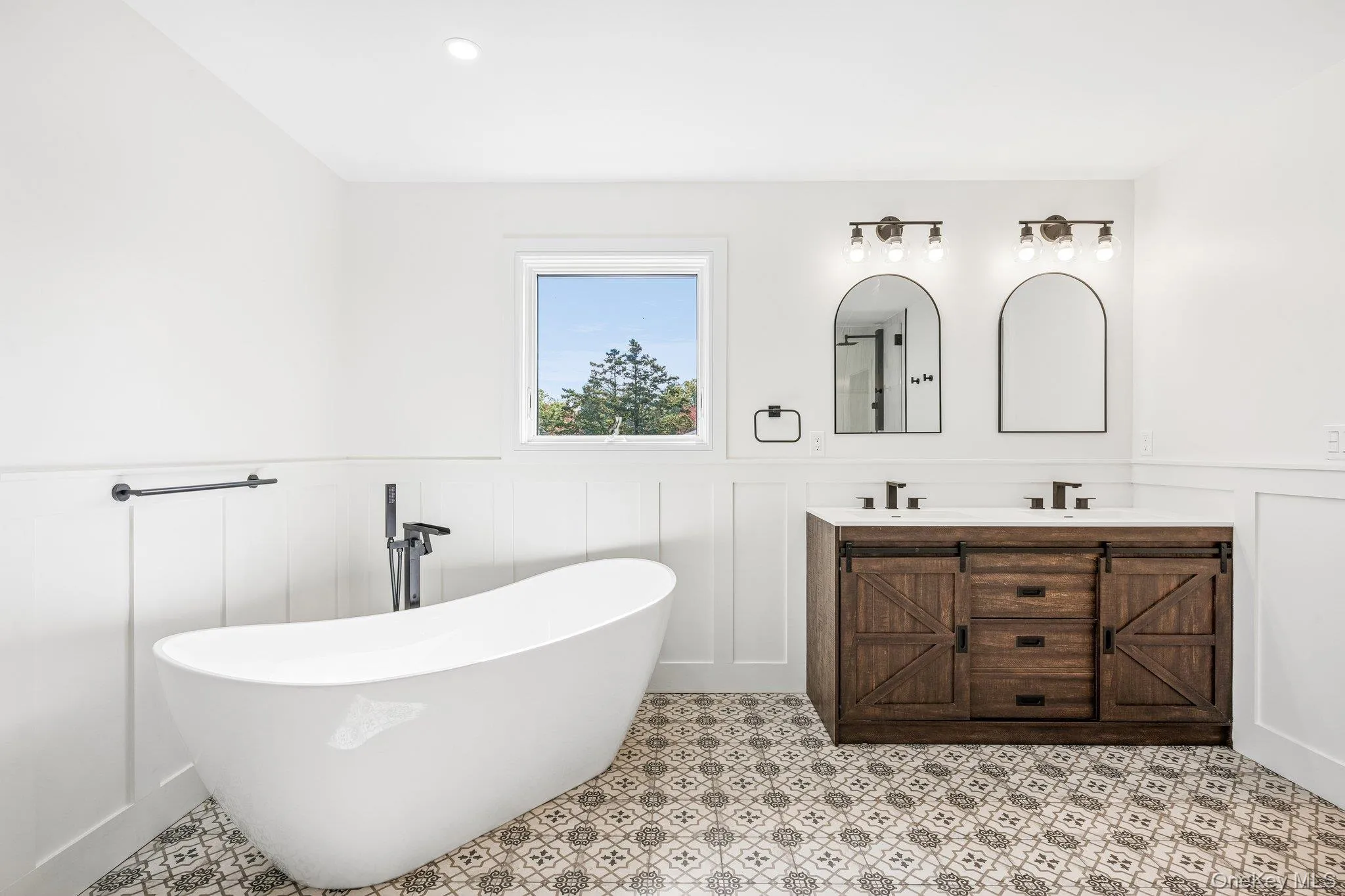 A freestanding tub beneath the window for long, unhurried soaks, the perfect close to afternoon tea at the Mad Batter Tea Room on Montauk Highway, about half a mile away. A freestanding tub beneath the window for long, unhurried soaks, the perfect close to afternoon tea at the Mad Batter Tea Room on Montauk Highway, about half a mile away.