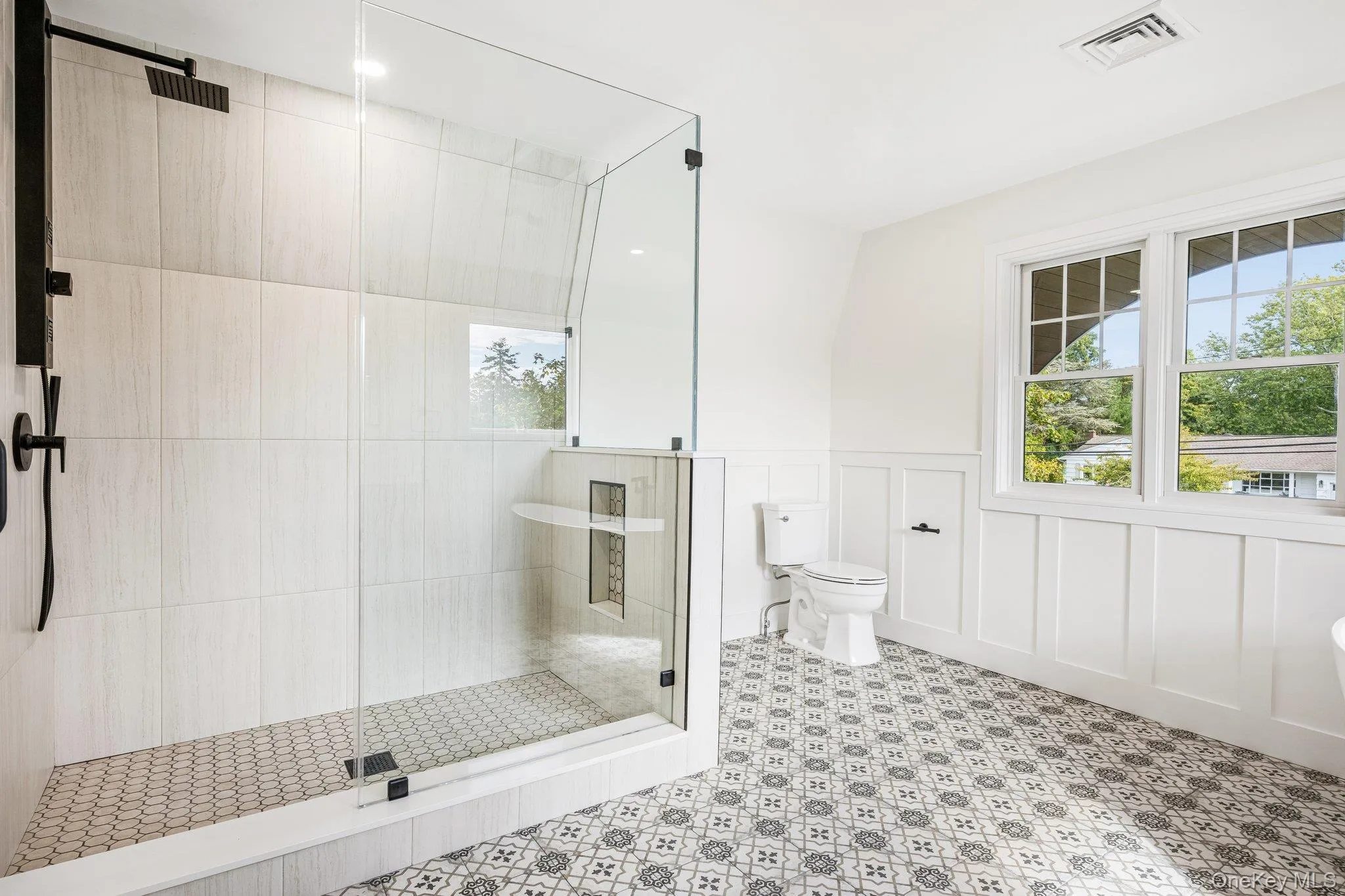 A frameless glass shower in the primary bath. Rinse off after a paddle from the Blue Point Dock, under half a mile away, then lunch at Flo's Luncheonette on Middle Road. A frameless glass shower in the primary bath. Rinse off after a paddle from the Blue Point Dock, under half a mile away, then lunch at Flo's Luncheonette on Middle Road.