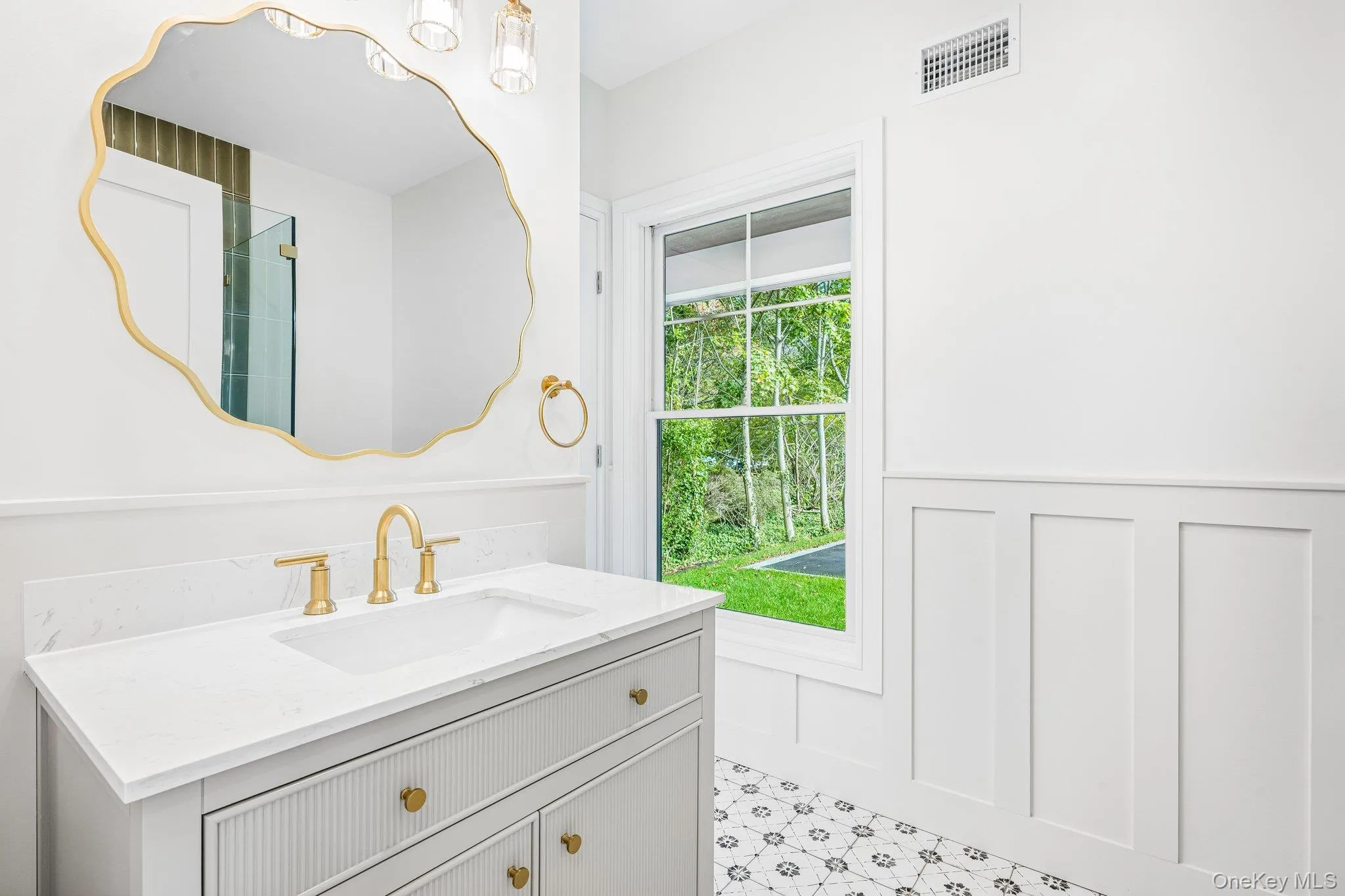 A sculpted gold mirror and white vanity bring jewel-box detail, made for an evening at the Blue Point Brewing tasting room on West Main Street in neighboring Patchogue. A sculpted gold mirror and white vanity bring jewel-box detail, made for an evening at the Blue Point Brewing tasting room on West Main Street in neighboring Patchogue.
