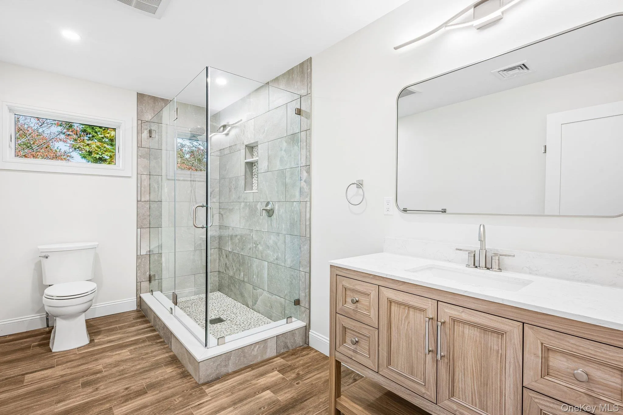 A full bath with glass shower and warm wood vanity. Tomorrow's plan: the Eggs Amsterdam at JT's Cafe on Montauk Highway, under a mile away, then a lap of the Nature Preserve. A full bath with glass shower and warm wood vanity. Tomorrow's plan: the Eggs Amsterdam at JT's Cafe on Montauk Highway, under a mile away, then a lap of the Nature Preserve.
