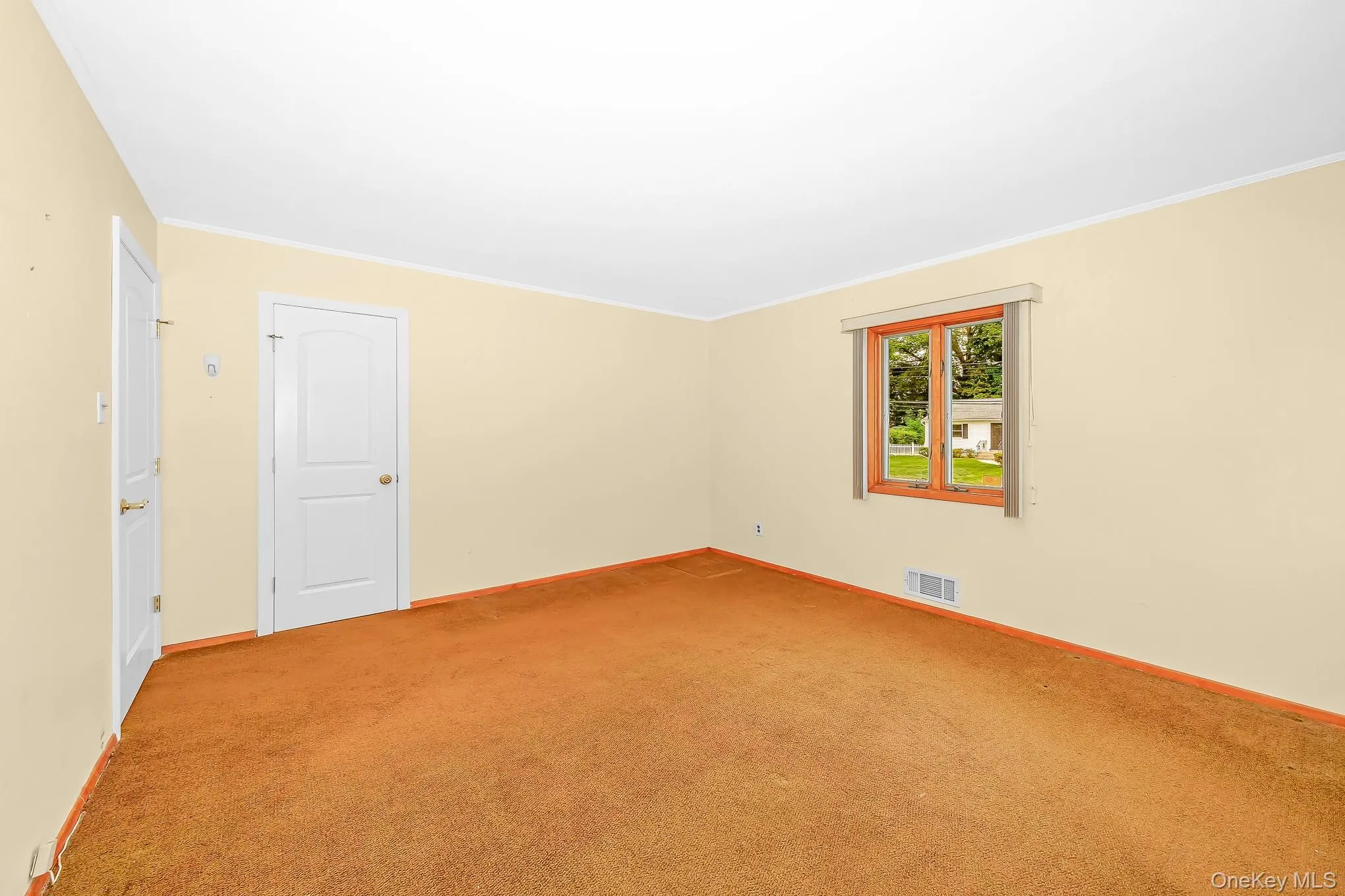 Primary bedroom carpeted. Hardwood under carpet Primary bedroom carpeted. Hardwood under carpet