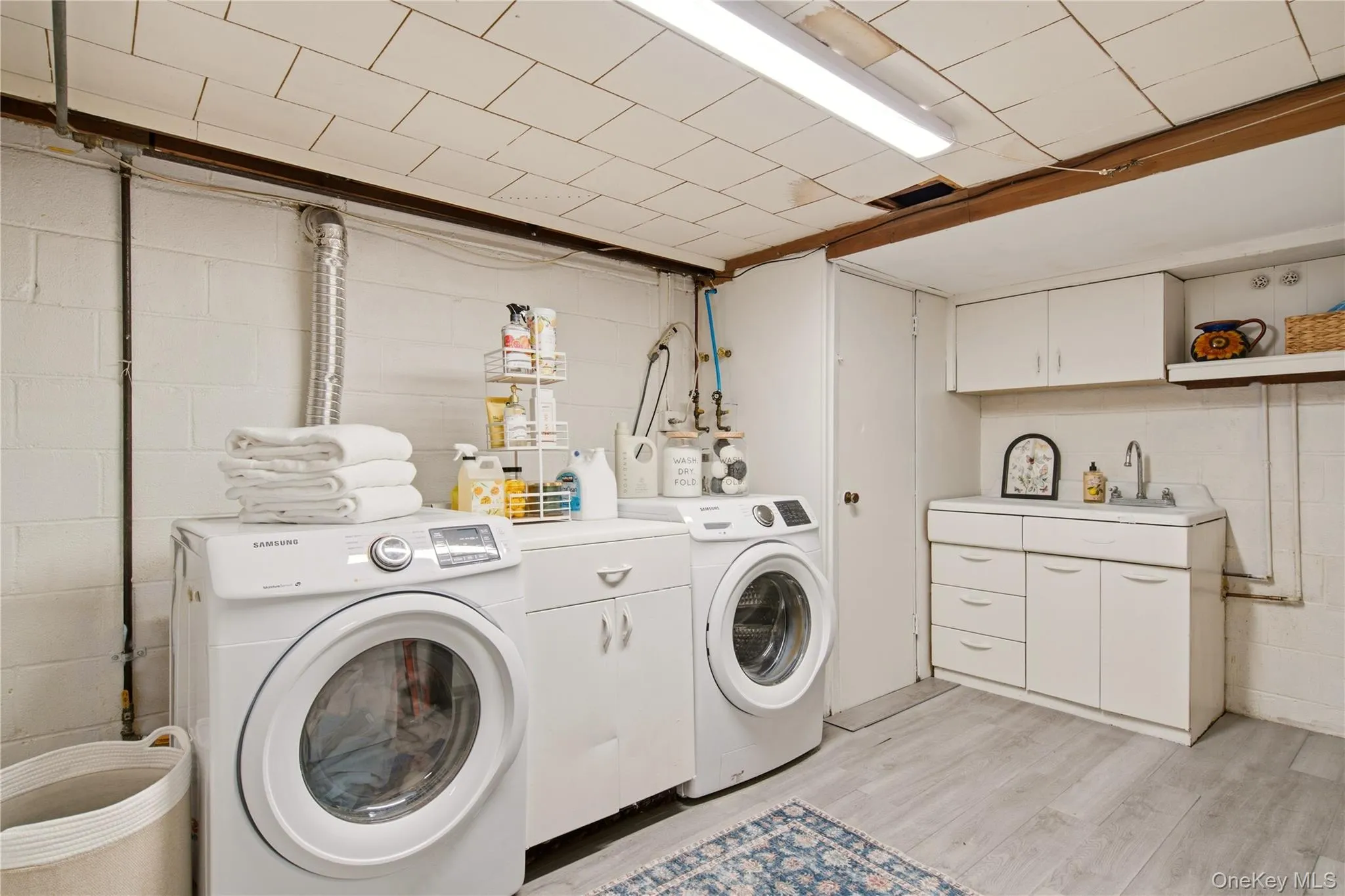 large laundry room with closet and sink large laundry room with closet and sink