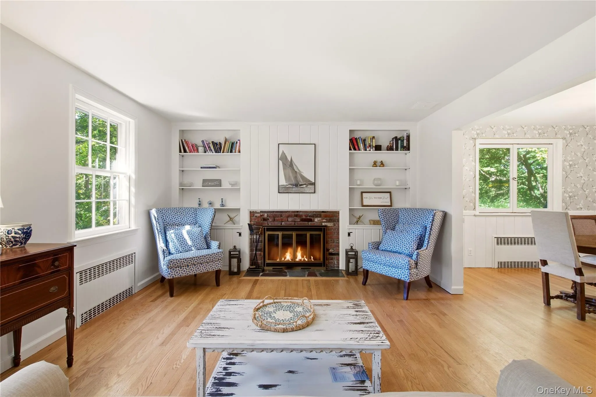 Formal living room has wood burning fireplace and overlooks front yard Formal living room has wood burning fireplace and overlooks front yard