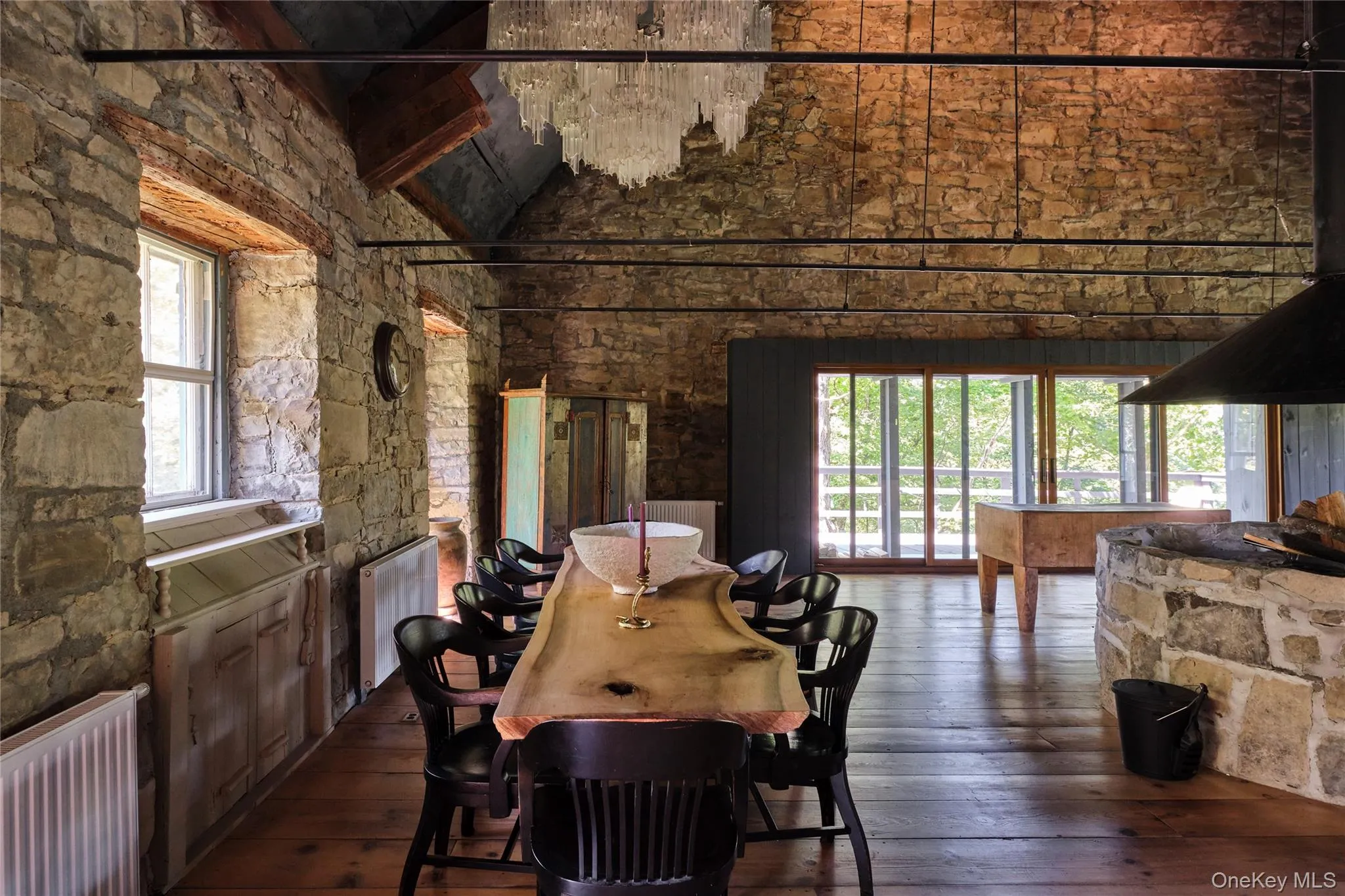 Dining space featuring dark wood-type flooring, radiator heating unit, high vaulted ceiling, and beamed ceiling Dining space featuring dark wood-type flooring, radiator heating unit, high vaulted ceiling, and beamed ceiling
