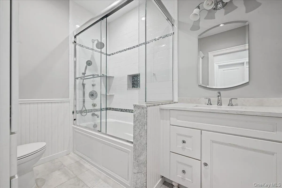 White vanity with a single basin sink and polished chrome faucet White vanity with a single basin sink and polished chrome faucet