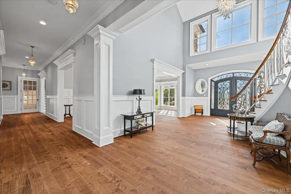 Wood-finish flooring throughout, with wainscoting and crown molding details Wood-finish flooring throughout, with wainscoting and crown molding details