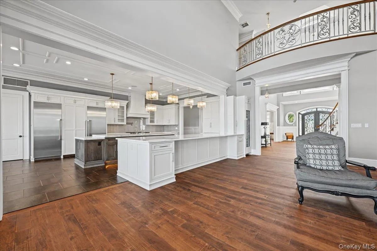 Expansive hardwood-finish flooring with a grand two-story ceiling Expansive hardwood-finish flooring with a grand two-story ceiling