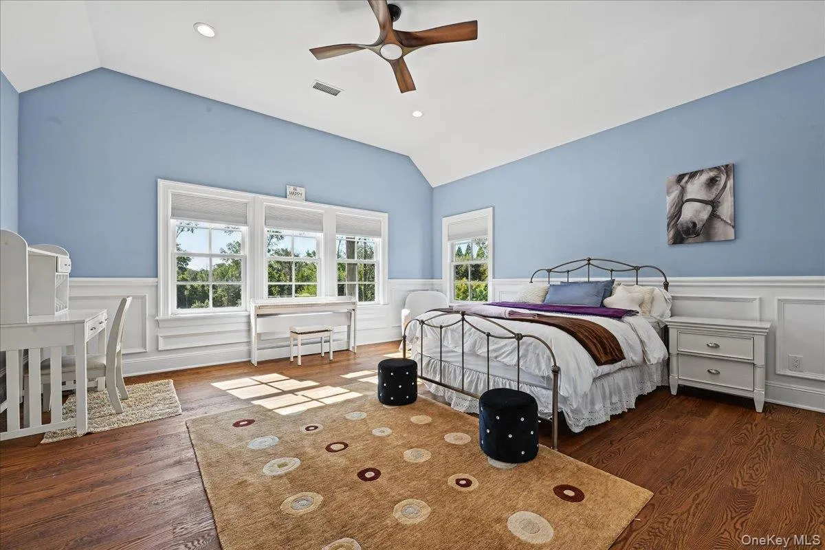 Vaulted ceiling with a wood-finish ceiling fan, recessed lighting, and rich wood-finish flooring Vaulted ceiling with a wood-finish ceiling fan, recessed lighting, and rich wood-finish flooring