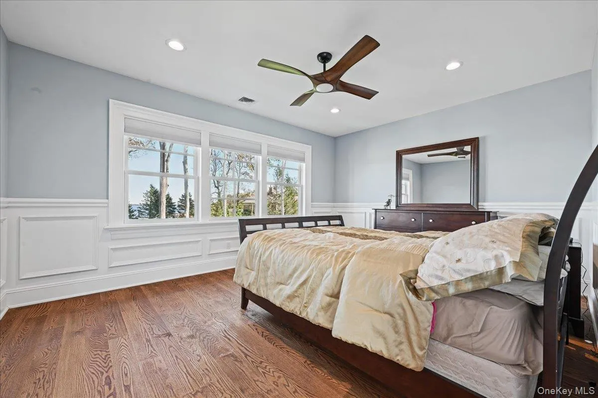 Wood-finish flooring, wainscoting, recessed lighting, ceiling fan, and large windows Wood-finish flooring, wainscoting, recessed lighting, ceiling fan, and large windows