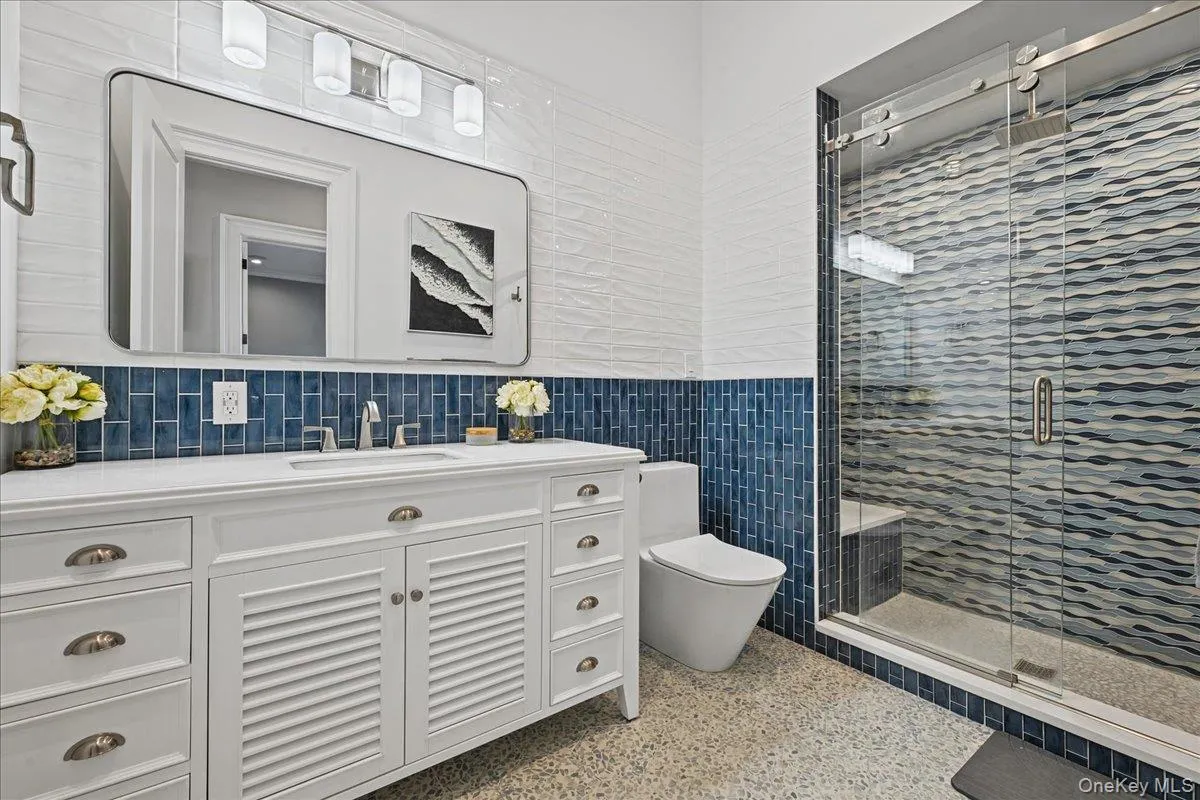 White double vanity with a rectangular undermount sink, brushed nickel faucet, and cup pulls White double vanity with a rectangular undermount sink, brushed nickel faucet, and cup pulls