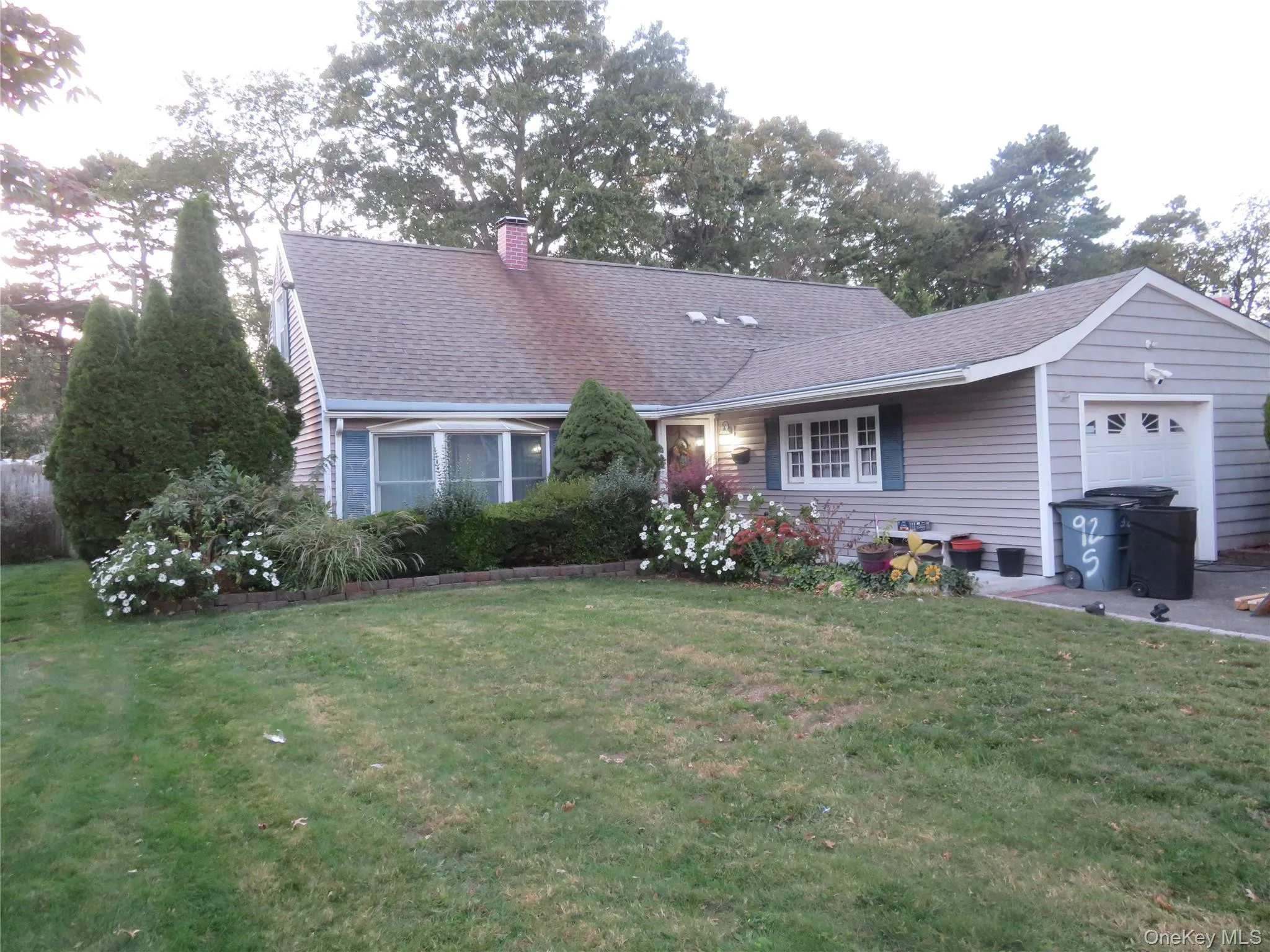 Gray shingle siding with a front-facing attached garage Gray shingle siding with a front-facing attached garage
