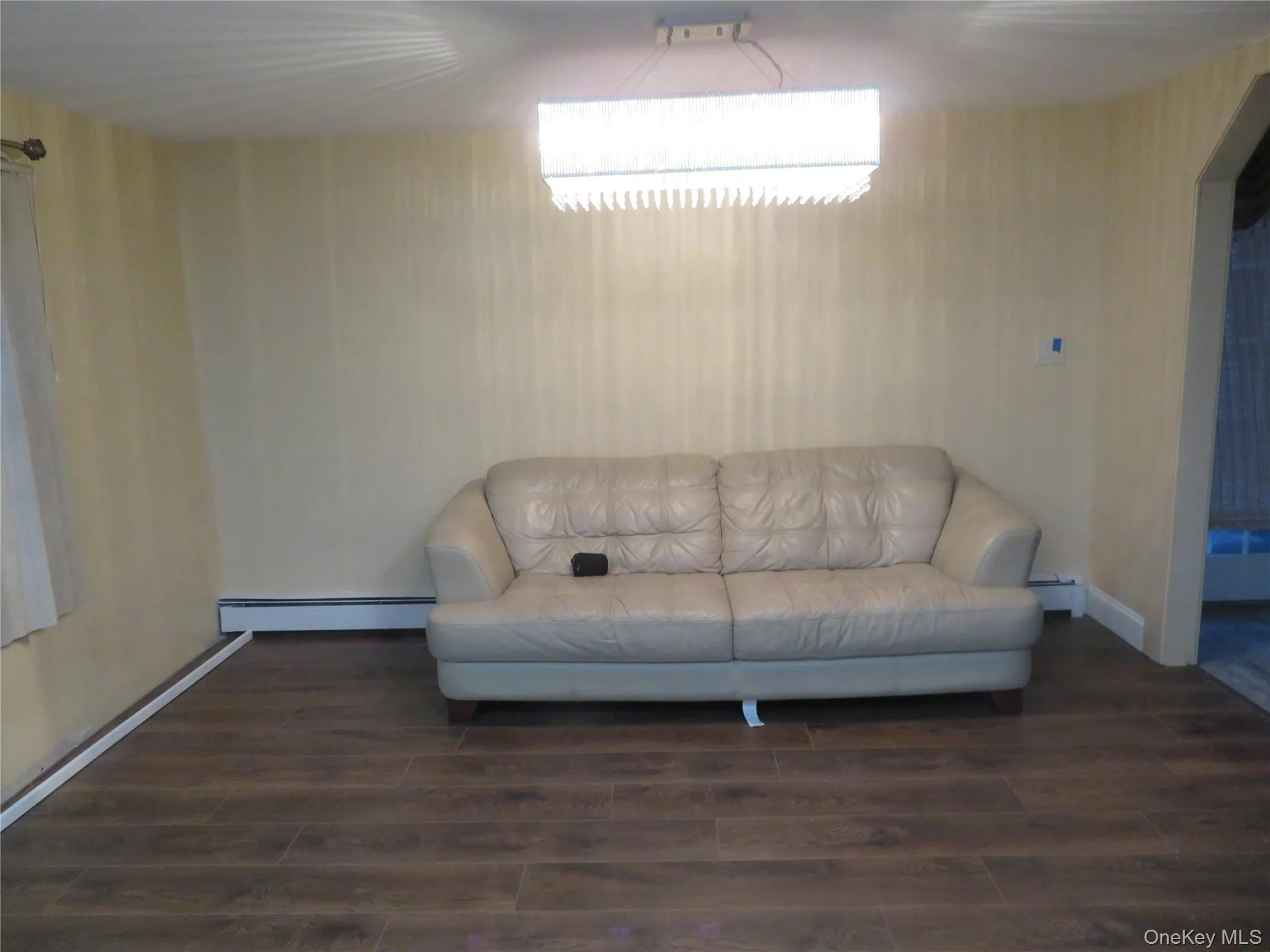 Wood-finish flooring with a modern linear ceiling fixture Wood-finish flooring with a modern linear ceiling fixture