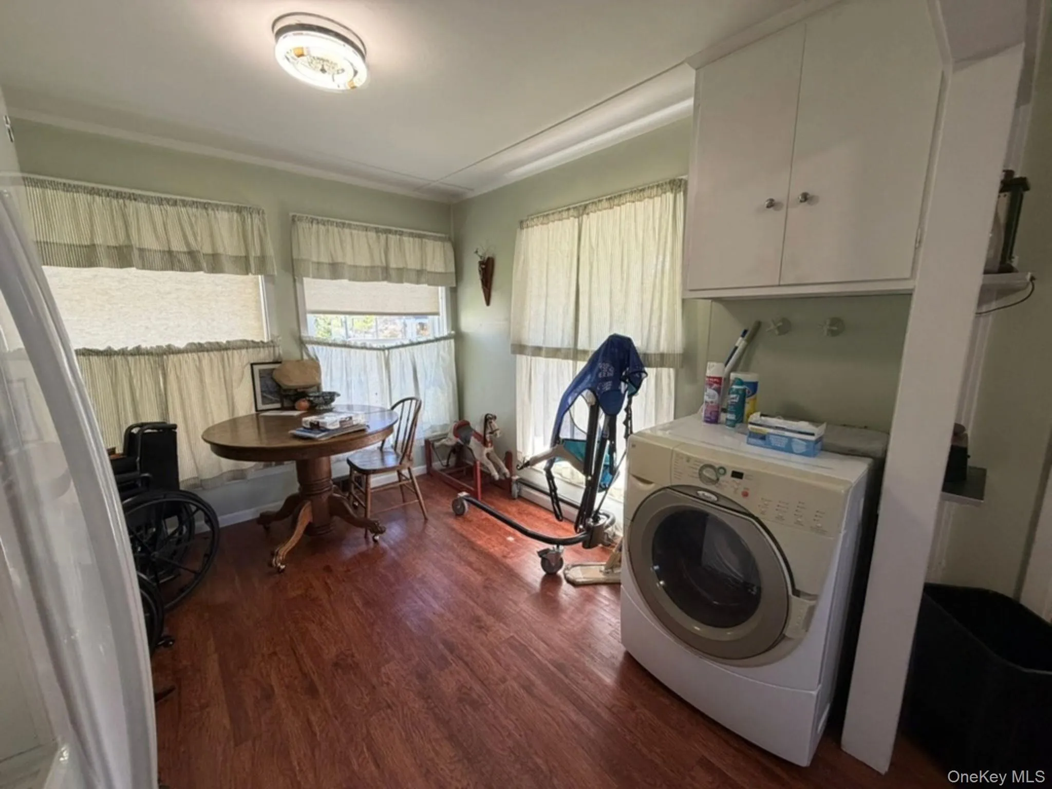 Laminate flooring, overhead lighting fixture, and multiple windows Laminate flooring, overhead lighting fixture, and multiple windows