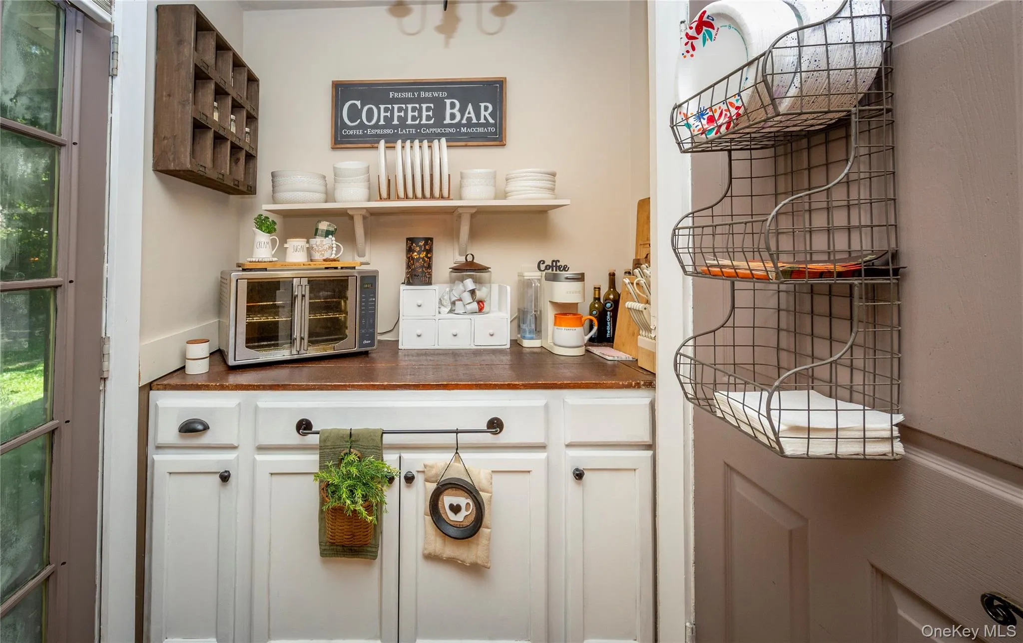 And could easily become the perfect coffee bar. Door on the left leads to the back patio. And could easily become the perfect coffee bar. Door on the left leads to the back patio.