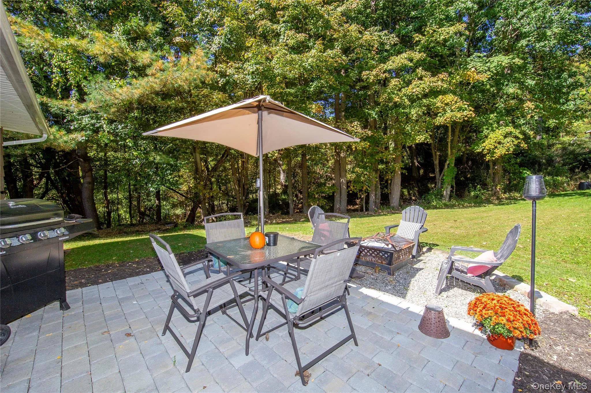 Complete with a BBQ grill, dining set, chairs, and a firepit. Complete with a BBQ grill, dining set, chairs, and a firepit.