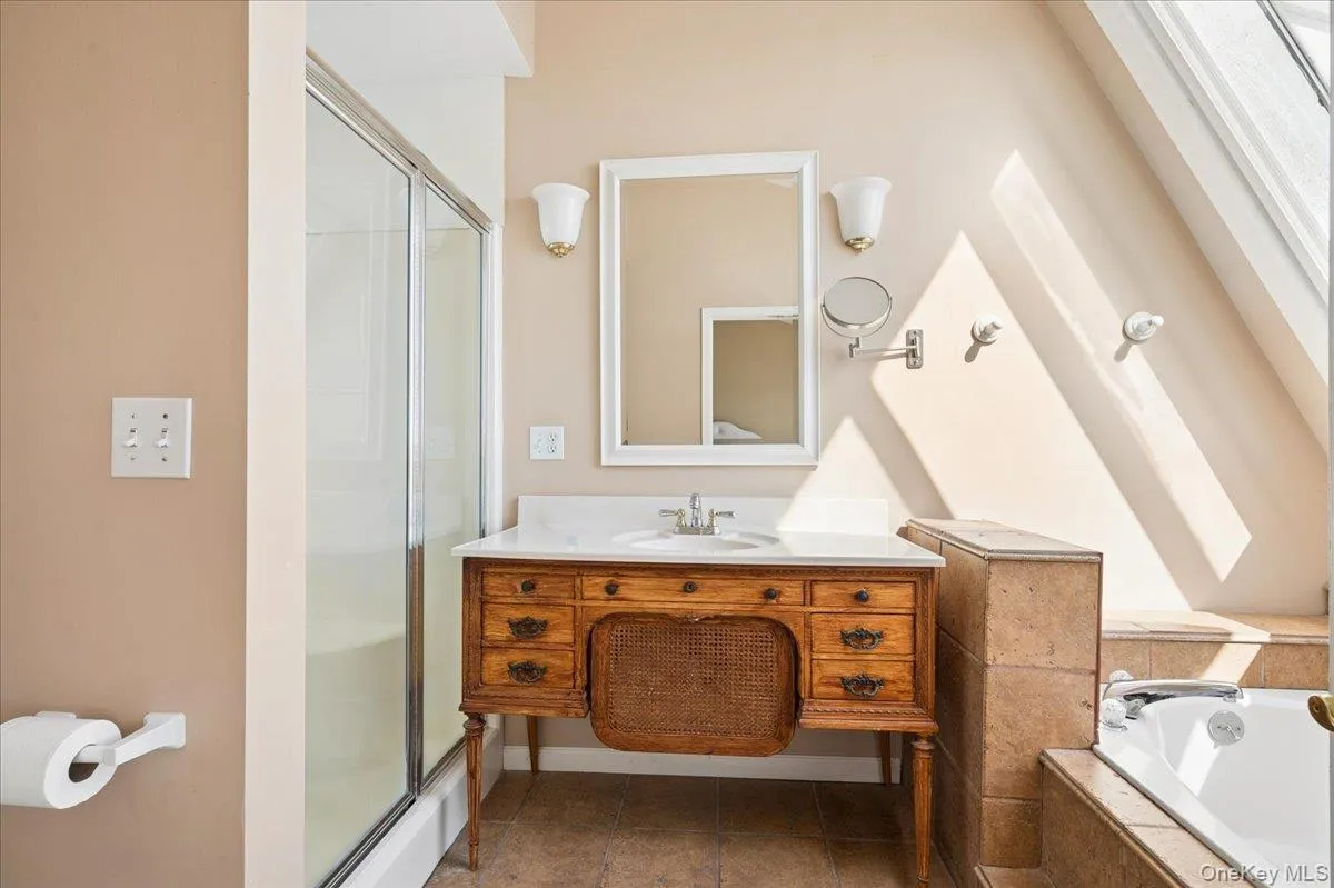 Primary En Suite with separate jacuzzi bathtub and sky light. Primary En Suite with separate jacuzzi bathtub and sky light.