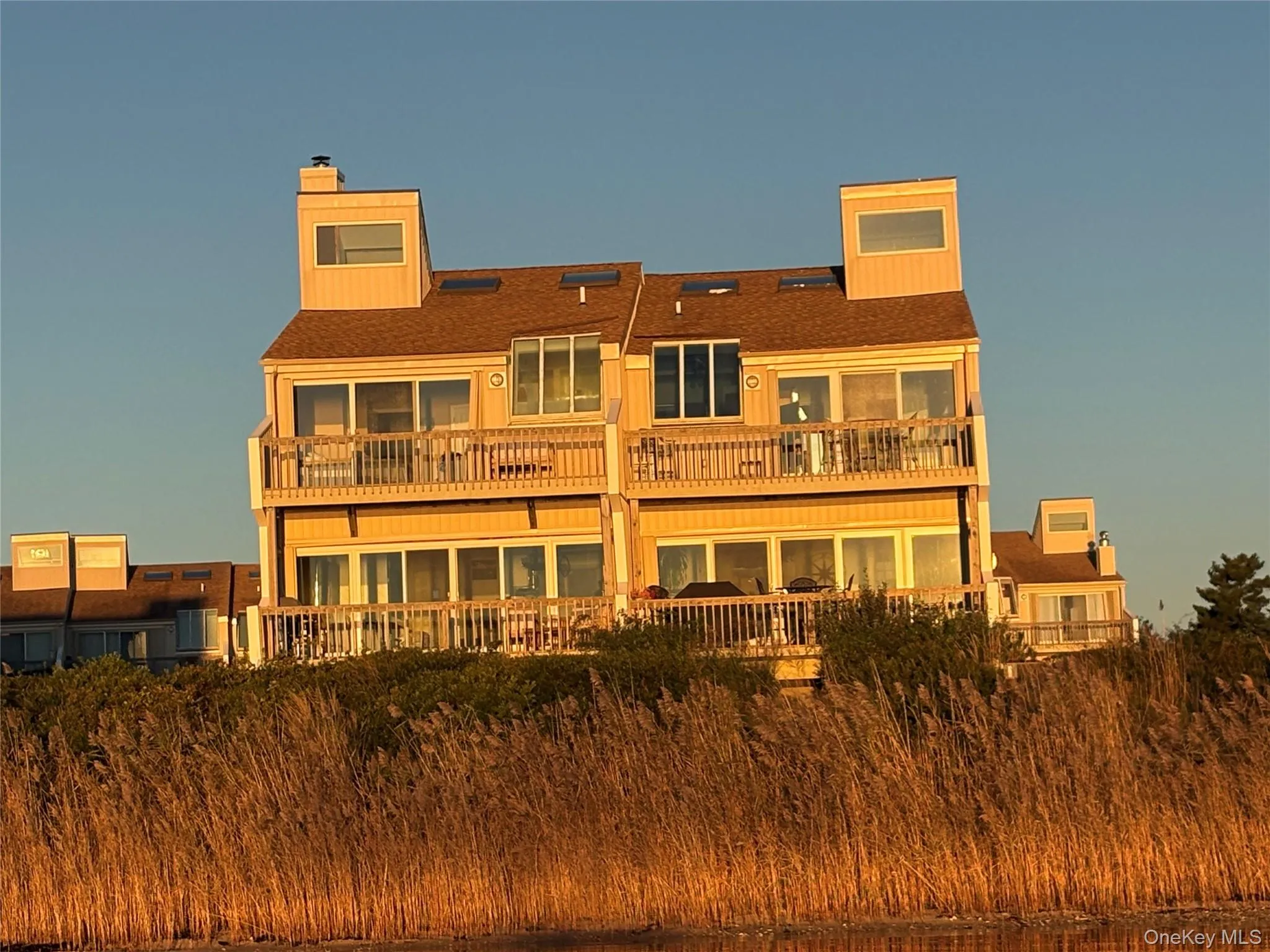 Sunset view of unit from the bay. Sunset view of unit from the bay.