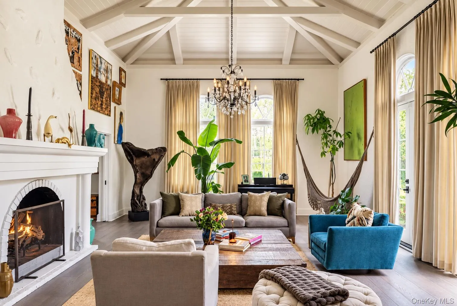 Living room with soaring ceilings, wood burning fireplace and doors to courtyard Living room with soaring ceilings, wood burning fireplace and doors to courtyard