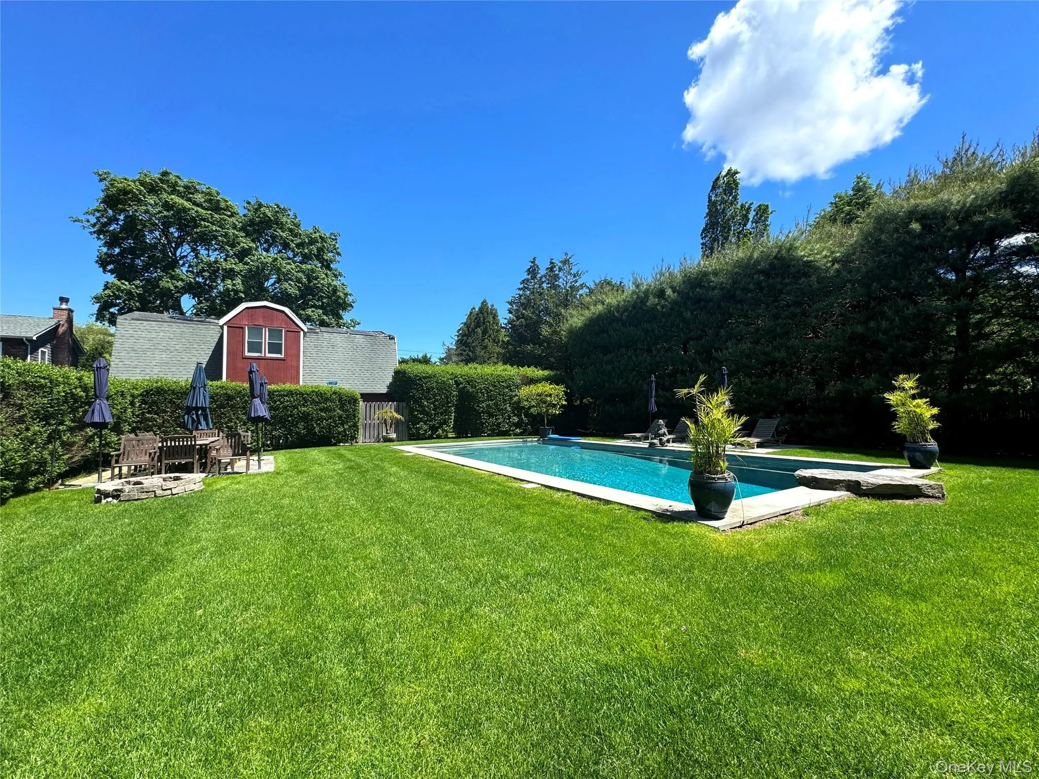 Outdoor pool featuring a lawn Outdoor pool featuring a lawn