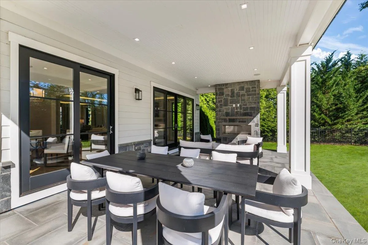 Covered patio with stone flooring, recessed lighting, and a stone-clad outdoor fireplace Covered patio with stone flooring, recessed lighting, and a stone-clad outdoor fireplace