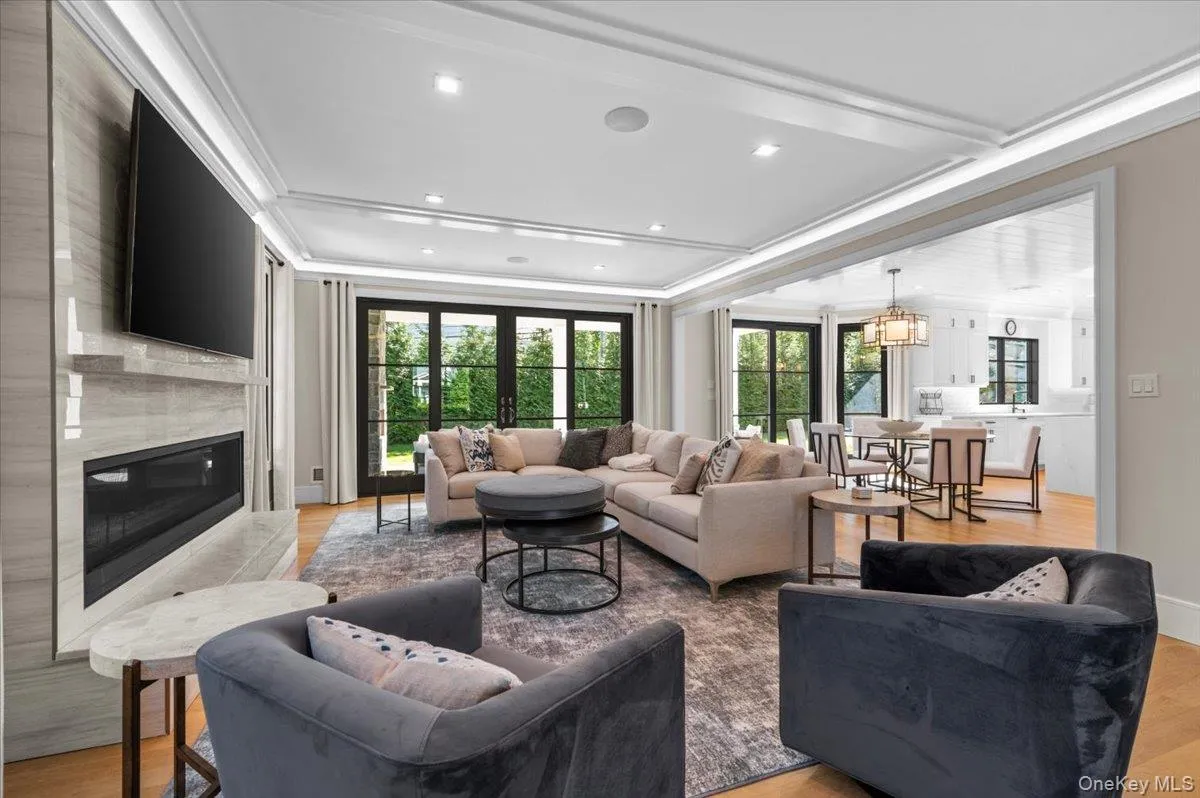 Den with gas fireplace, open concept with view into the kitchen, breakfast room, and backyard Den with gas fireplace, open concept with view into the kitchen, breakfast room, and backyard