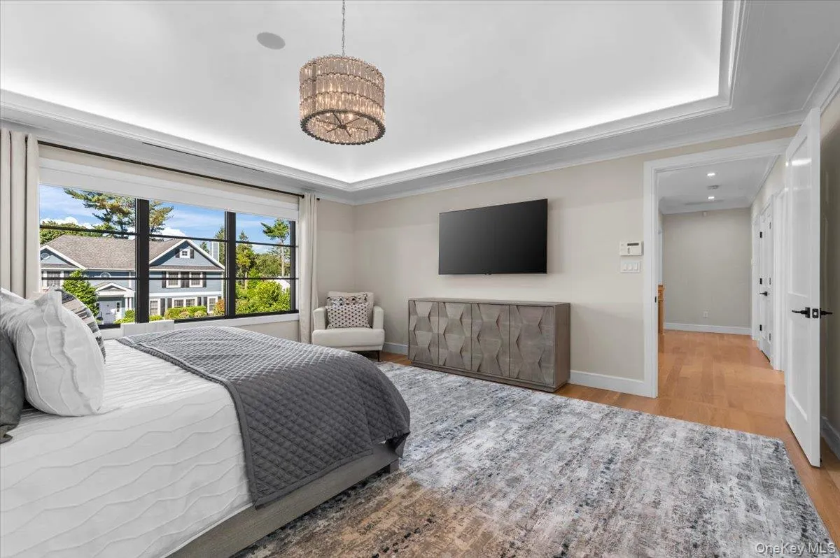 Recessed lighting, crown molding, wood-finish flooring, and a large window Recessed lighting, crown molding, wood-finish flooring, and a large window