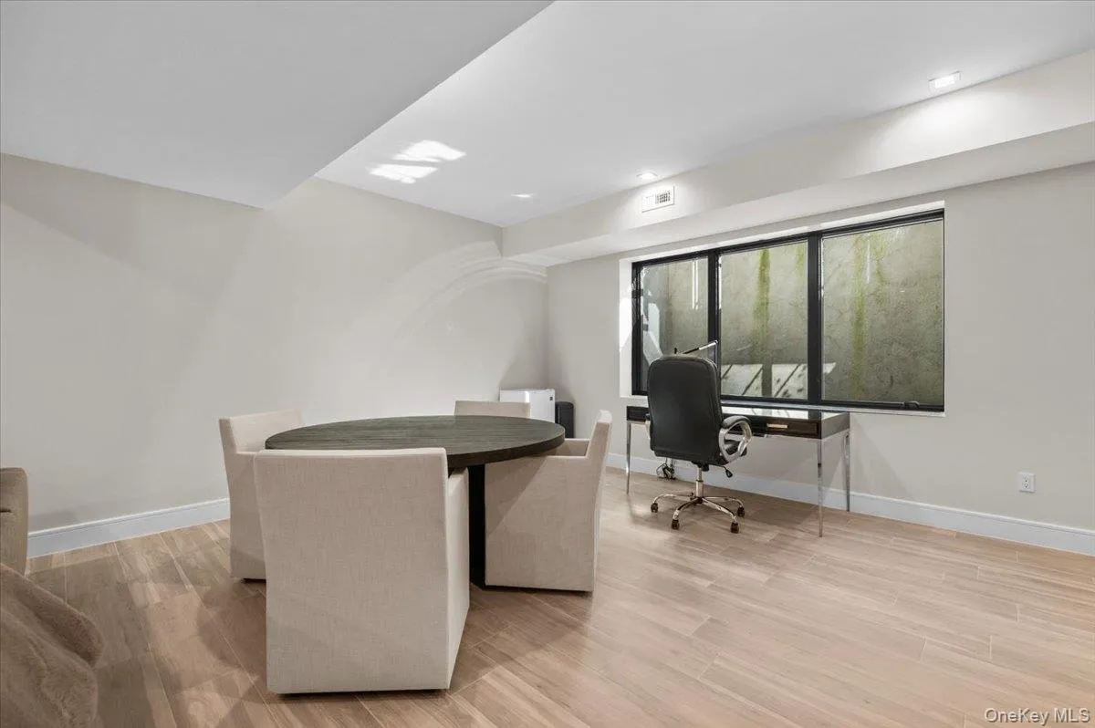 Recessed lighting, light wood-finish flooring, and a large window Recessed lighting, light wood-finish flooring, and a large window