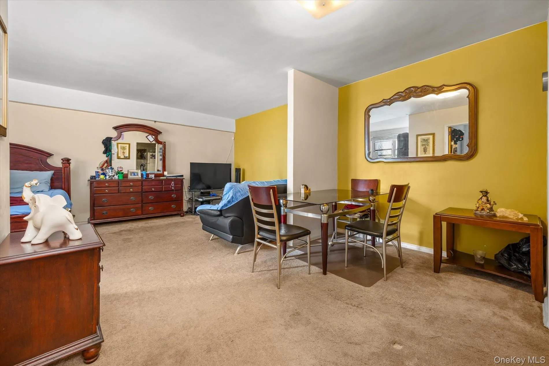 Carpeted flooring, recessed lighting, and a partial wall separation Carpeted flooring, recessed lighting, and a partial wall separation
