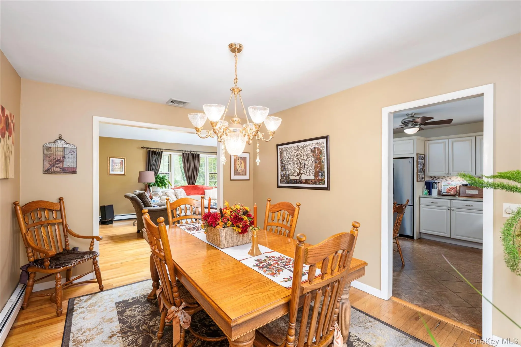 Dining area featuring wood flooring, and wide archway to living room Dining area featuring wood flooring, and wide archway to living room