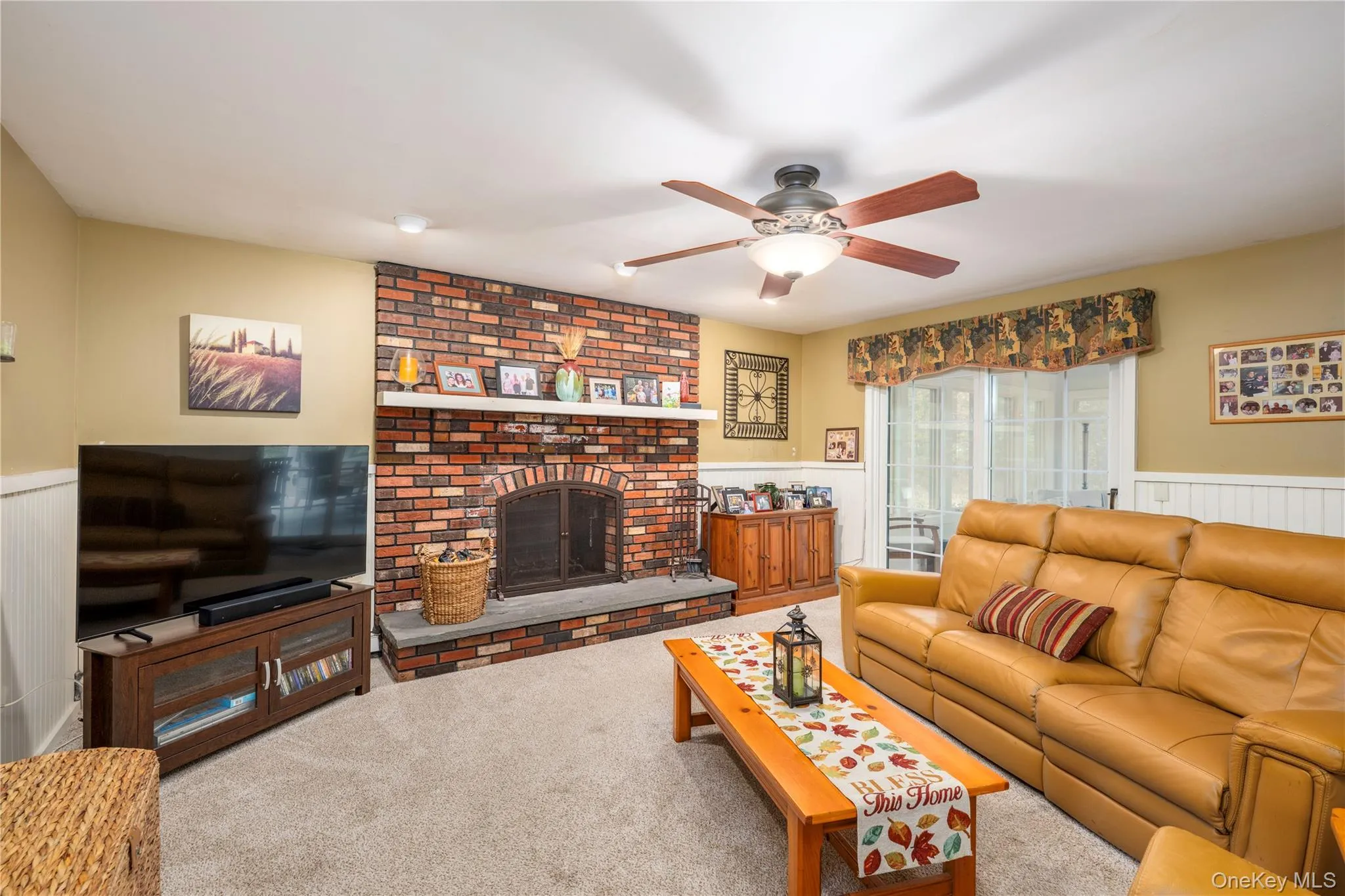 Brick Fireplace featuring a stone hearth with slider to enclosed 4 Season Room Brick Fireplace featuring a stone hearth with slider to enclosed 4 Season Room