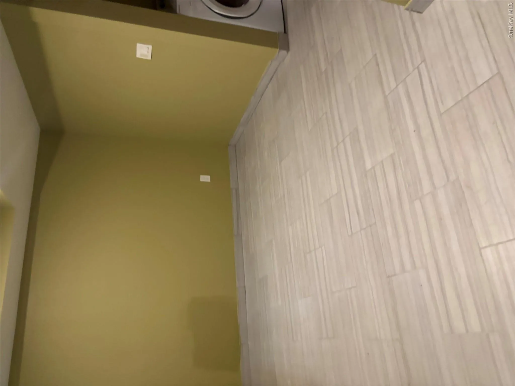 Tile flooring with a light wood-finish pattern and coordinating tile baseboards Tile flooring with a light wood-finish pattern and coordinating tile baseboards
