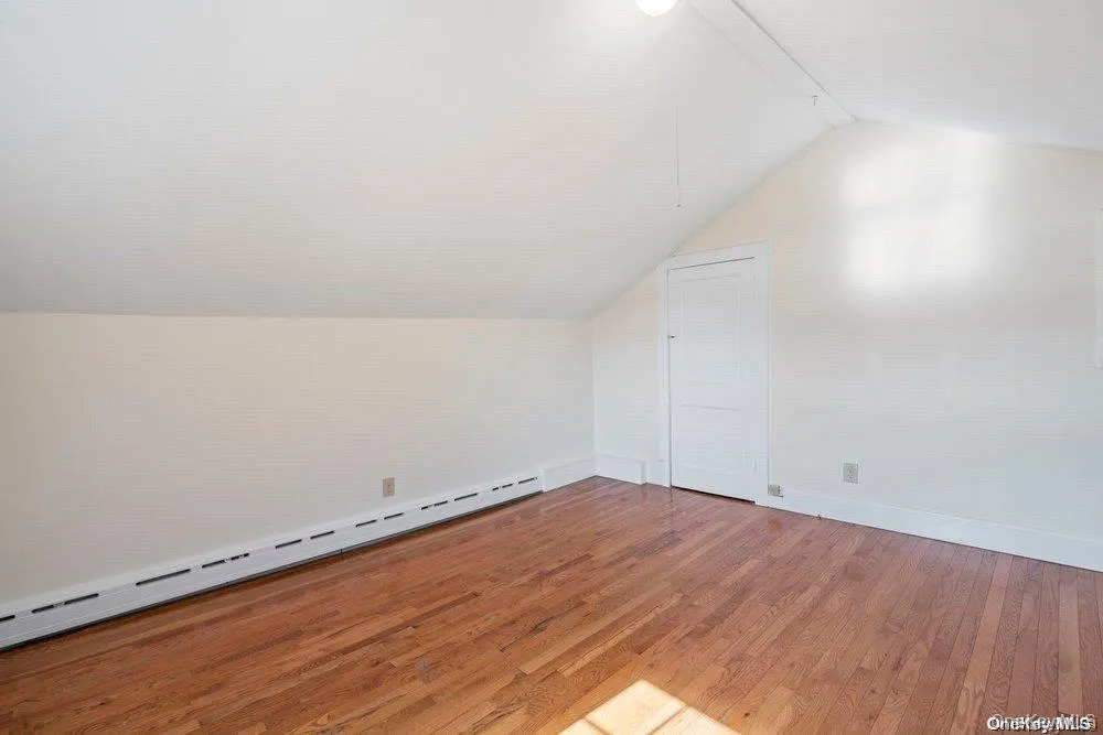 Loft with hardwood floors and closet Loft with hardwood floors and closet