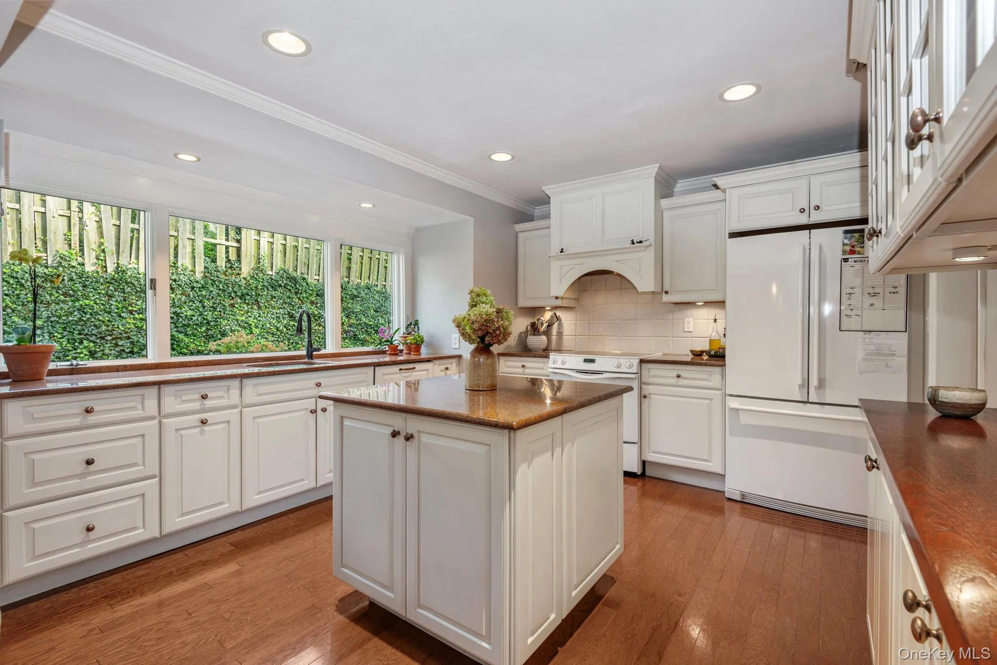 Beautiful kitchen with island and newer refrigerator. Beautiful kitchen with island and newer refrigerator.