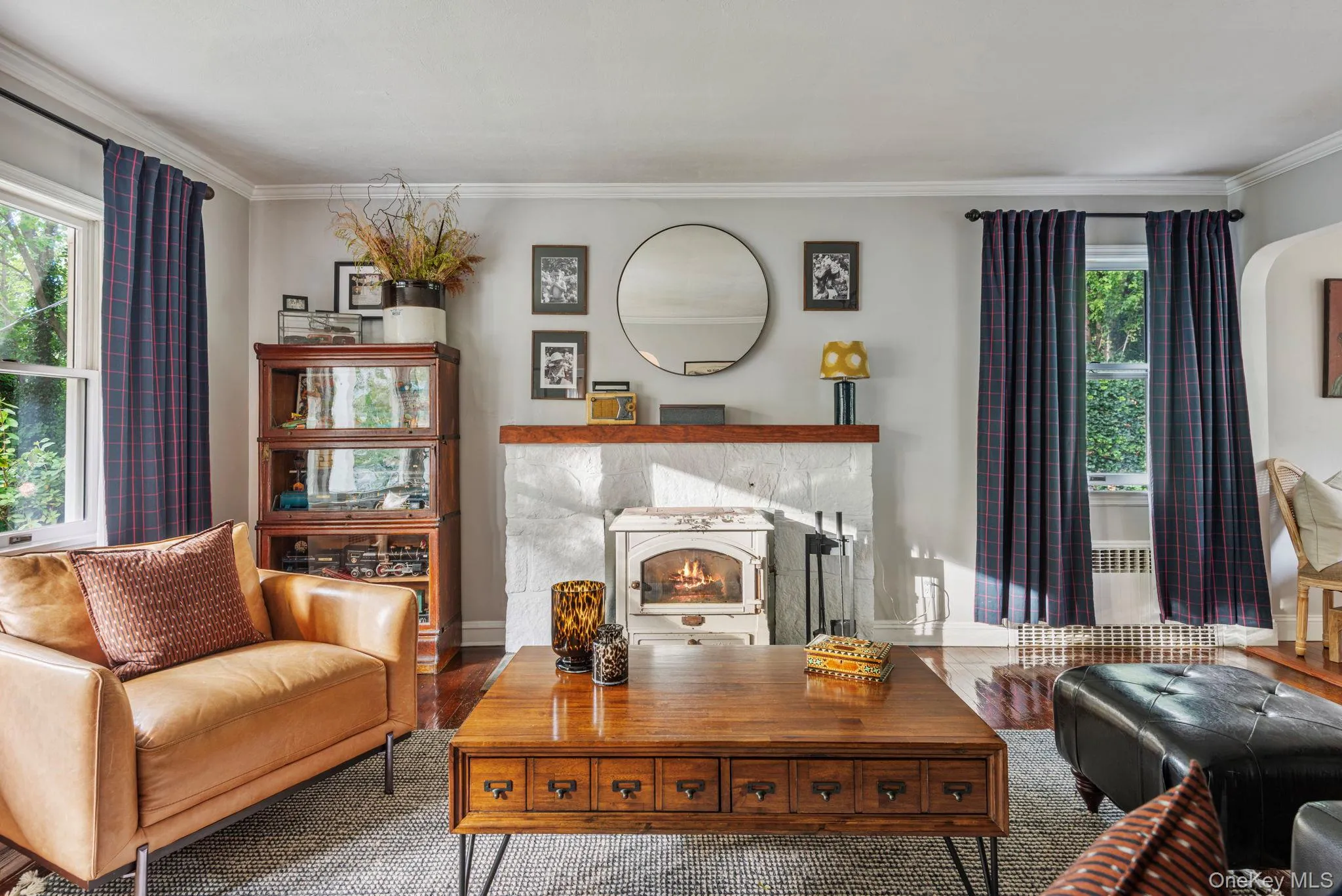 Cozy living room with wood burning stove and views to the porch. Cozy living room with wood burning stove and views to the porch.