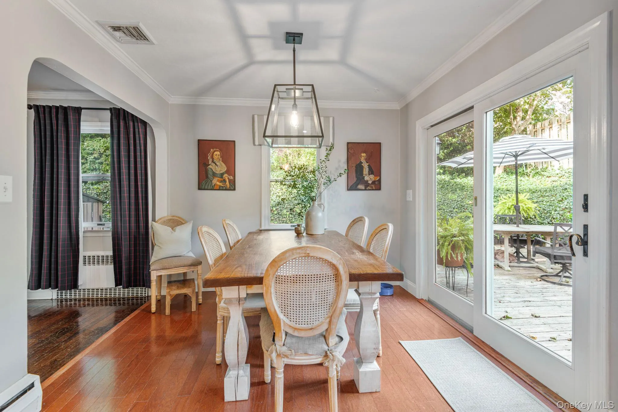 Sunny dining room with sliders out to the gardens. Sunny dining room with sliders out to the gardens.