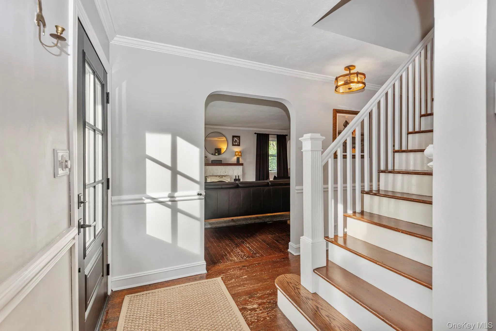 Classic staircase and arches frame the entrance foyer. Classic staircase and arches frame the entrance foyer.