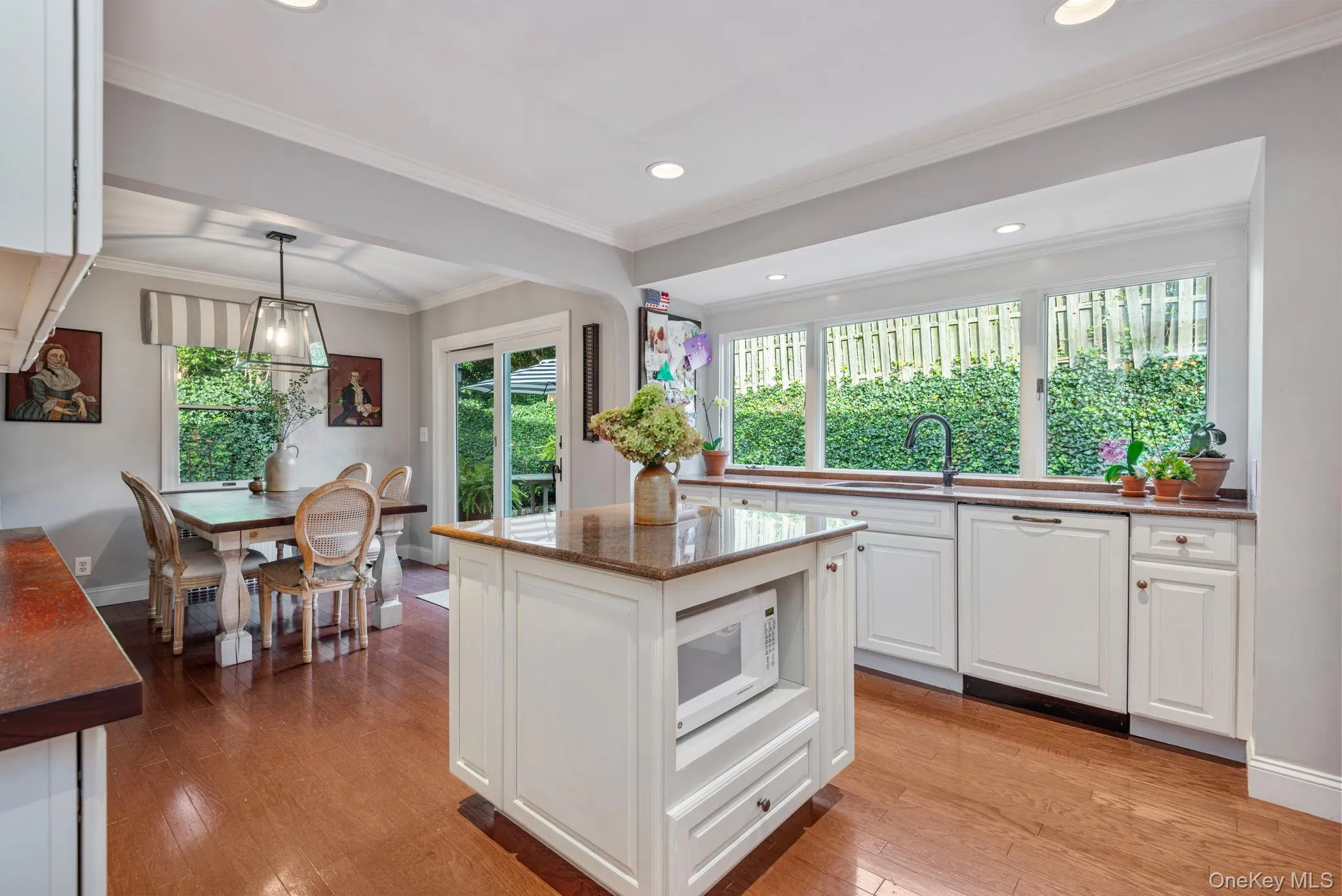 Bright and sunny classic kitchen with large windows looking out to the gardens. Bright and sunny classic kitchen with large windows looking out to the gardens.