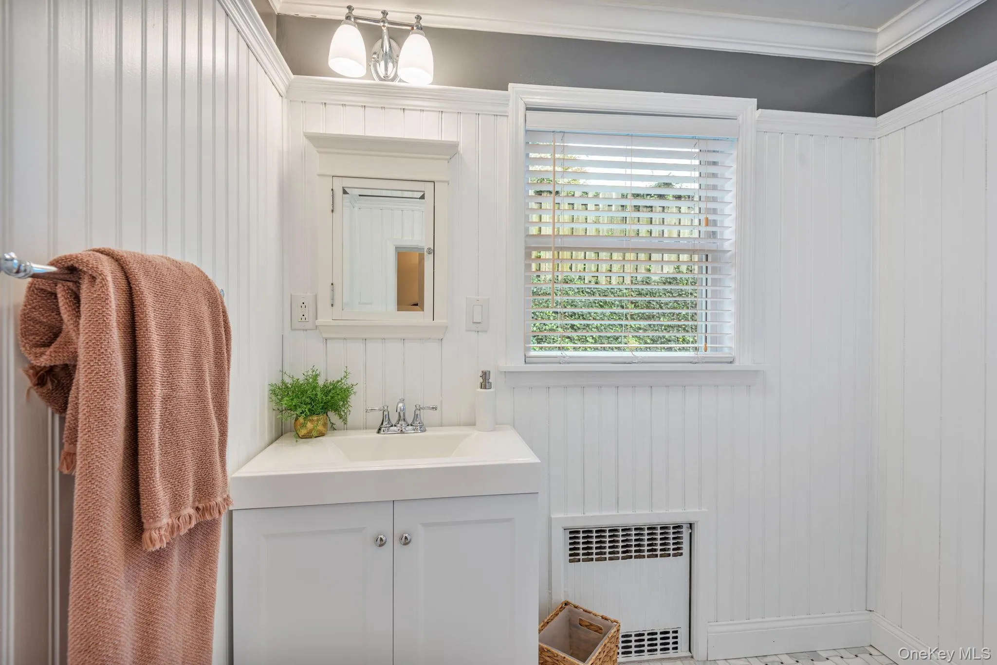 Full bathroom with marble basketweave floors and beadboard paneling on first floor. Full bathroom with marble basketweave floors and beadboard paneling on first floor.