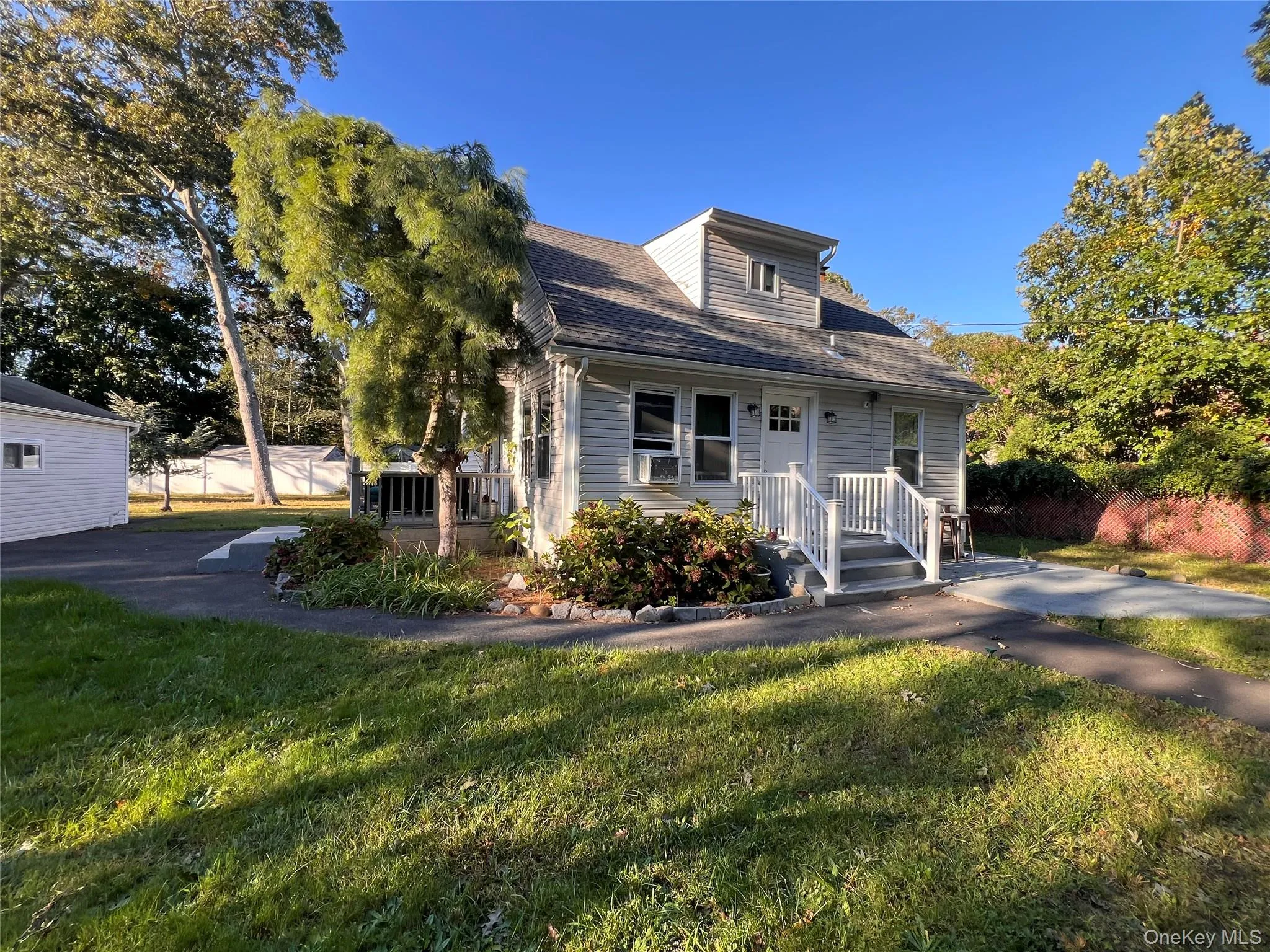 Exterior featuring a front porch with white railings and stairs Exterior featuring a front porch with white railings and stairs
