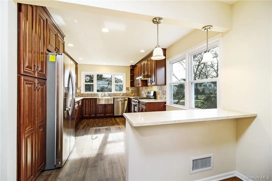 Eat-in-kitchen and breakfast bar. Photos taken when house was empty prior to occupancy. Eat-in-kitchen and breakfast bar. Photos taken when house was empty prior to occupancy.